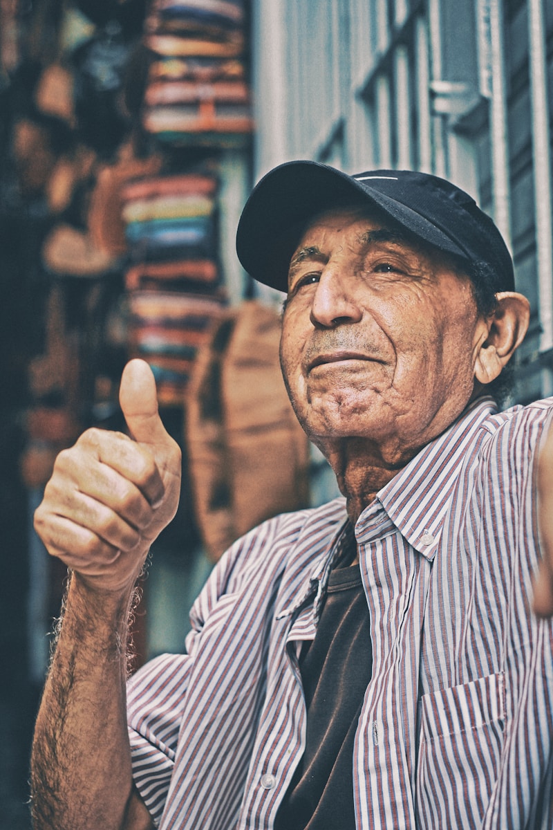 man making thumbs up sign because he has auto insurance